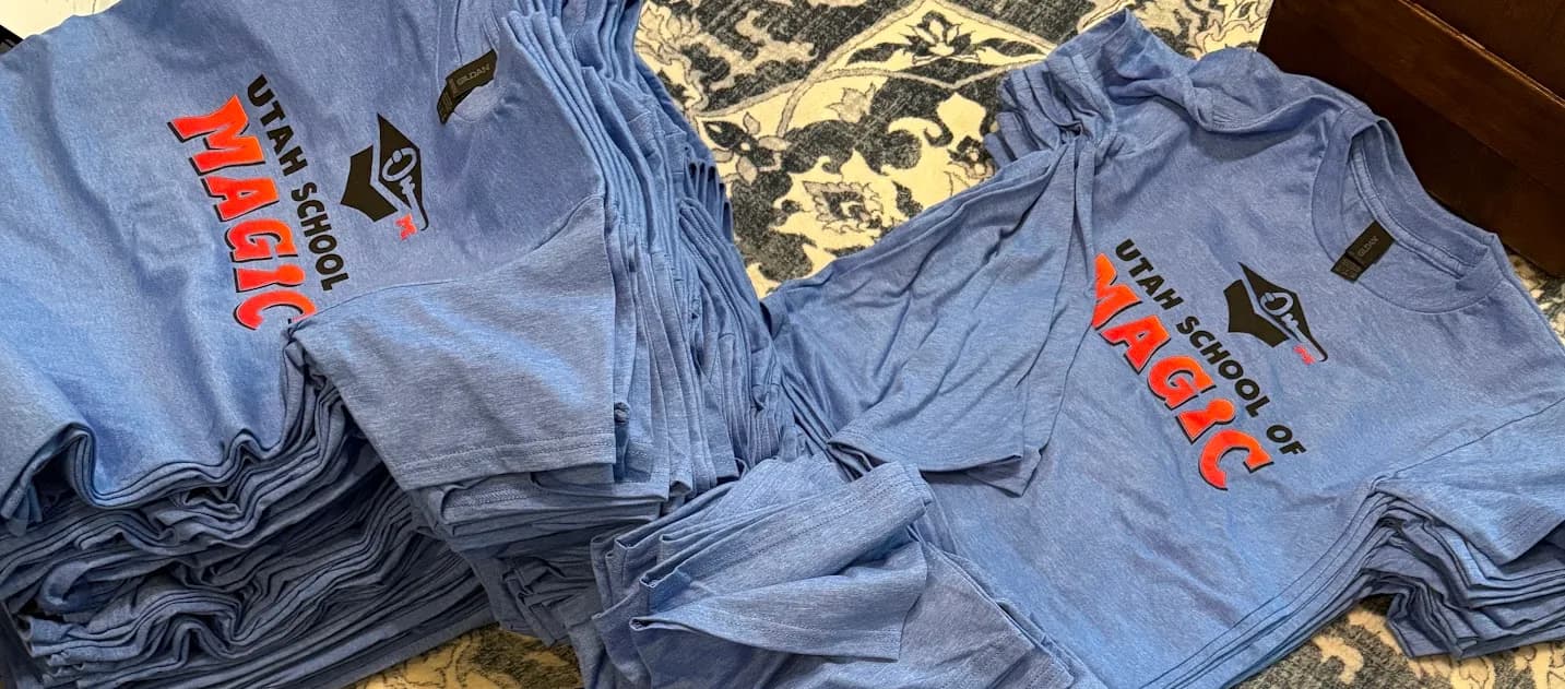 Scott's actual order - Utah School of Magic tees printed by Koala-Tees on heather blue Gildan shirts